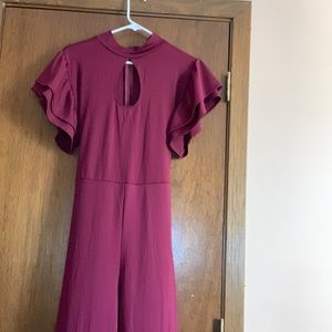 A burgundy jumper with a little circle around the cleavage